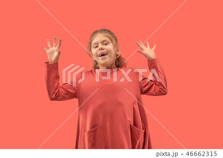 Cute little girl in coral dress with long hair smiling to camera Cute little girl in coral dress with long hair smiling to camera 46662315