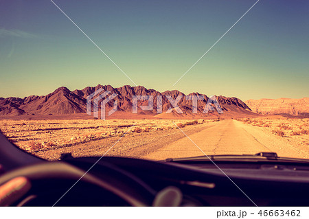 Driving a car on the road in the desert Driving a car on the road in the desert 46663462