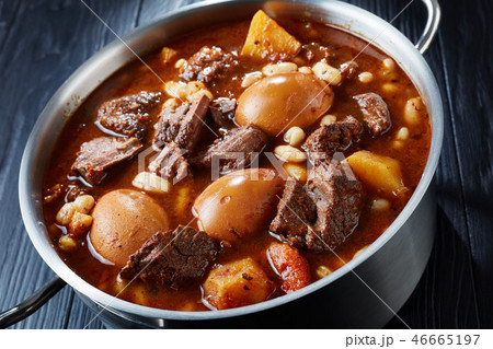 Jewish Cholent in a metal casserole, close-up Jewish Cholent in a metal casserole, close-up 46665197