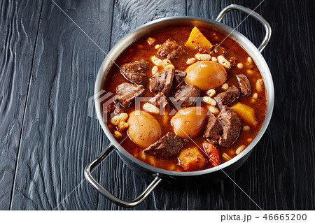 Jewish Cholent in a metal casserole, close-up Jewish Cholent in a metal casserole, close-up 46665200
