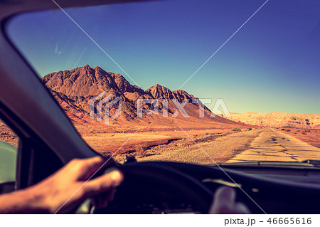 Driving a car on the road in the desert Driving a car on the road in the desert 46665616