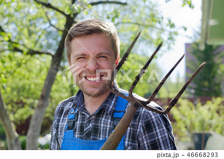 European man with pitchfork is angry, losing his mind. 46668293