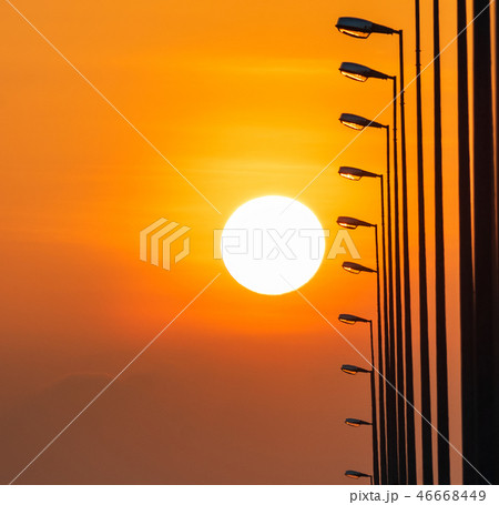 Street lamp poles and beautiful sunset sky. 46668449