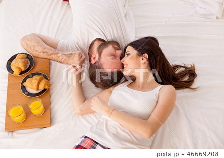 husband and wife in bed in the morning woke up to breakfast in bed husband and wife in bed in the morning woke up to breakfast in bed 46669208