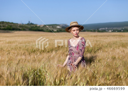 fashionable woman farmer in field of wheat harvesting rye 46669599