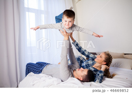 mom dad and young son sleep on the bed in the bedroom mom dad and young son sleep on the bed in the bedroom 46669852