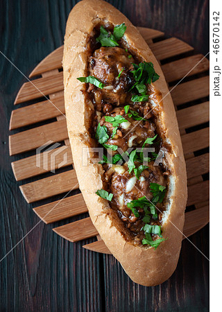 Hot dog bun stuffed with meatballs 46670142