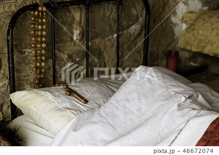 Old white bed with Christian crucifix Old white bed with Christian crucifix 46672074