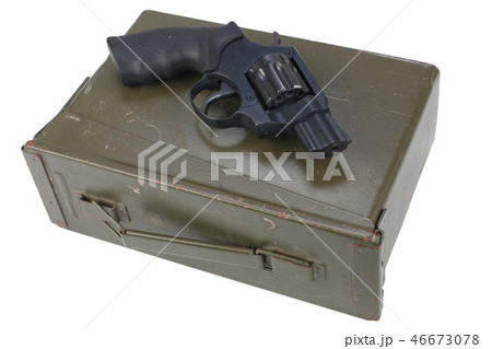 Revolver on the ammunition box 46673078