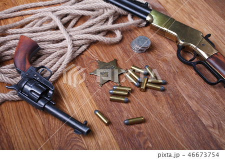 Wild west rifle, ammunition and sheriff badge Wild west rifle, ammunition and sheriff badge 46673754