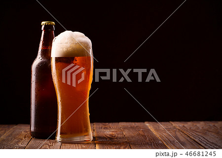 Photo of buttle and glass of beer Photo of buttle and glass of beer 46681245