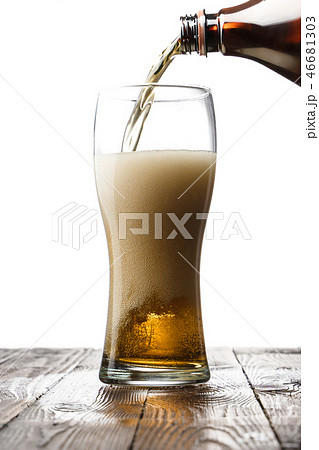 Frosty glass of light beer on wood table Frosty glass of light beer on wood table 46681303