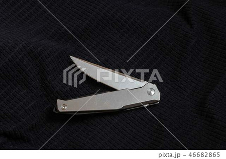 Knife with a metal handle in a bent position.  46682865