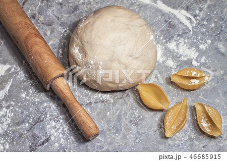 bowl of raw dough with a rolling pin and shells of durum wheat bowl of raw dough with a rolling pin and shells of durum wheat 46685915