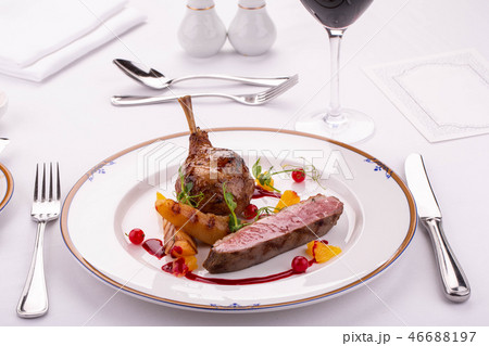 A leg of a turkey with the vegetables fried on a g 46688197