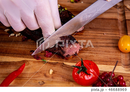 The venison brisket fried on a grill with tomatoes The venison brisket fried on a grill with tomatoes 46688969