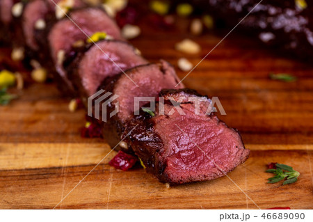 Venison pieces on a board with dried tomatoes 46689090