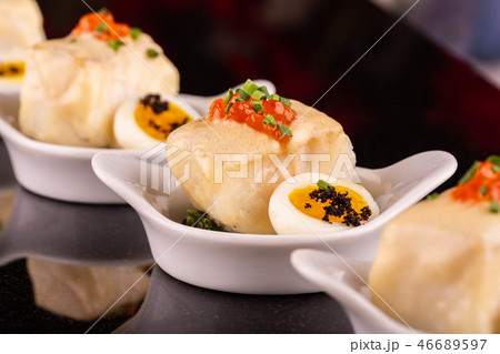 Fish fried with red caviar and quail egg 46689597