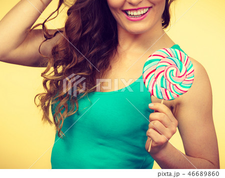 Woman charming girl with lollipop candy 46689860