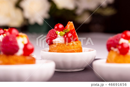 An orange dessert with red currant and raspberry An orange dessert with red currant and raspberry 46691656