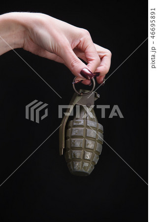 fragmentation grenade in woman hand fragmentation grenade in woman hand 46695891