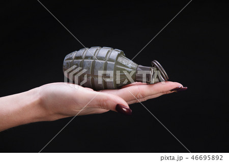 fragmentation grenade in woman hand fragmentation grenade in woman hand 46695892