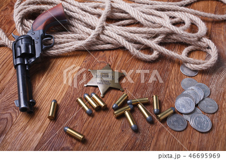Wild west rifle, ammunition and sheriff badge Wild west rifle, ammunition and sheriff badge 46695969