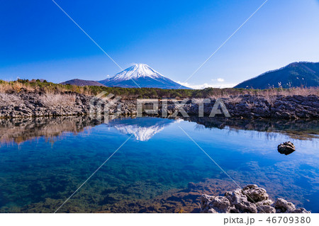 山梨県 本栖湖畔の溶岩地帯から望む富士山の写真素材