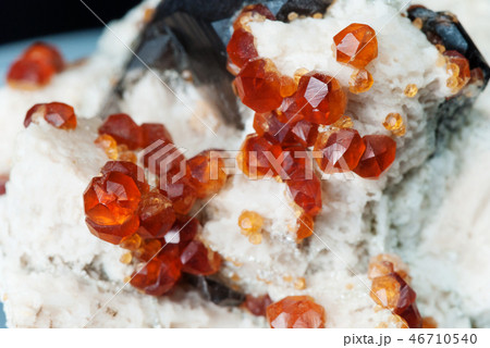 Orange crystals of spessartite garnet Orange crystals of spessartite garnet 46710540