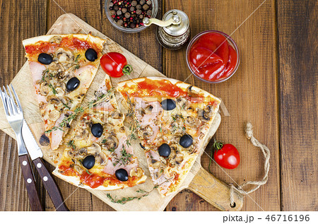 Sliced pizza with mozzarella cheese, ham, olives Sliced pizza with mozzarella cheese, ham, olives 46716196