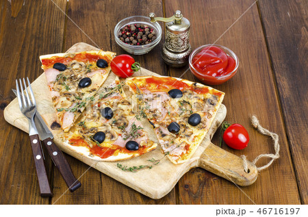 Sliced pizza with mozzarella cheese, ham, olives Sliced pizza with mozzarella cheese, ham, olives 46716197
