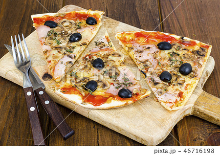 Sliced pizza with mozzarella cheese, ham, olives Sliced pizza with mozzarella cheese, ham, olives 46716198