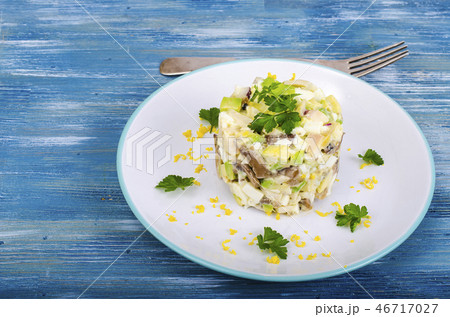 Tasty salad with squid and avocado on blue  46717027