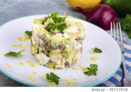 Tasty salad with squid and avocado on blue Tasty salad with squid and avocado on blue 46717028
