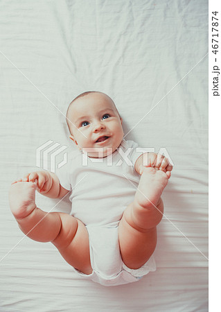 Portrait of a baby lying on the bed Portrait of a baby lying on the bed 46717874