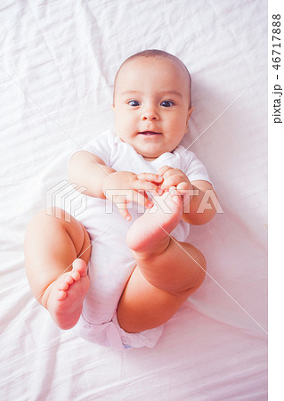 Portrait of a baby lying on the bed Portrait of a baby lying on the bed 46717888