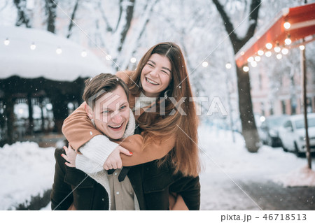 beautiful young couple having fun on a snowy street 46718513