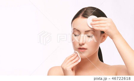Home face care. Girl remove makeup. Woman hand 46722618