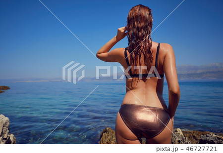 Bikini girl on the beach. Young beautiful woman in bikini on the Bikini girl on the beach. Young beautiful woman in bikini on the 46727721