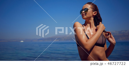 Bikini girl on the beach. Young beautiful woman in bikini on the Bikini girl on the beach. Young beautiful woman in bikini on the 46727722