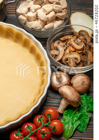 shortbread dough for baking quiche tart in baking form and ingredients 46728202