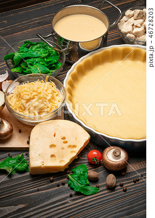 shortbread dough for baking quiche tart in baking form and ingredients 46728203