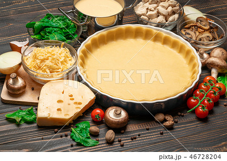 shortbread dough for baking quiche tart in baking form and ingredients 46728204