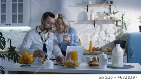 Husband joining wife in the kitchen for breakfast Husband joining wife in the kitchen for breakfast 46728397