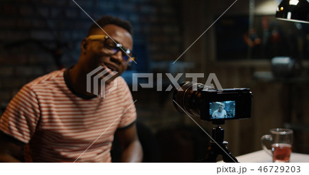 Young man talking on camera in a garage 46729203