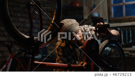 Two men working in a bicycle repair shop Two men working in a bicycle repair shop 46729213