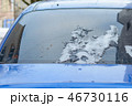 The rear glass of the car with snow residues that melted during the winter's thaw. 46730116