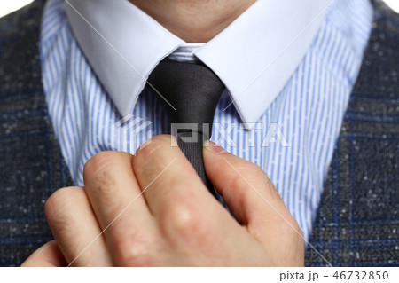 Male arm in blue suit set tie closeup Male arm in blue suit set tie closeup 46732850
