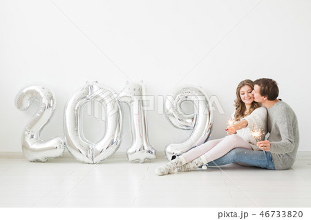 New 2019 Year is coming concept - loving young man and woman with silver colored numbers 46733820