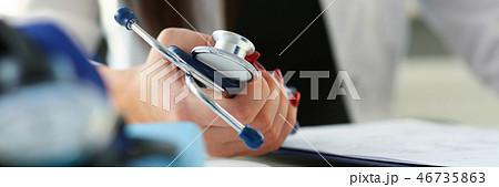 Female doctor hand hold phonendoscope in medical Female doctor hand hold phonendoscope in medical 46735863